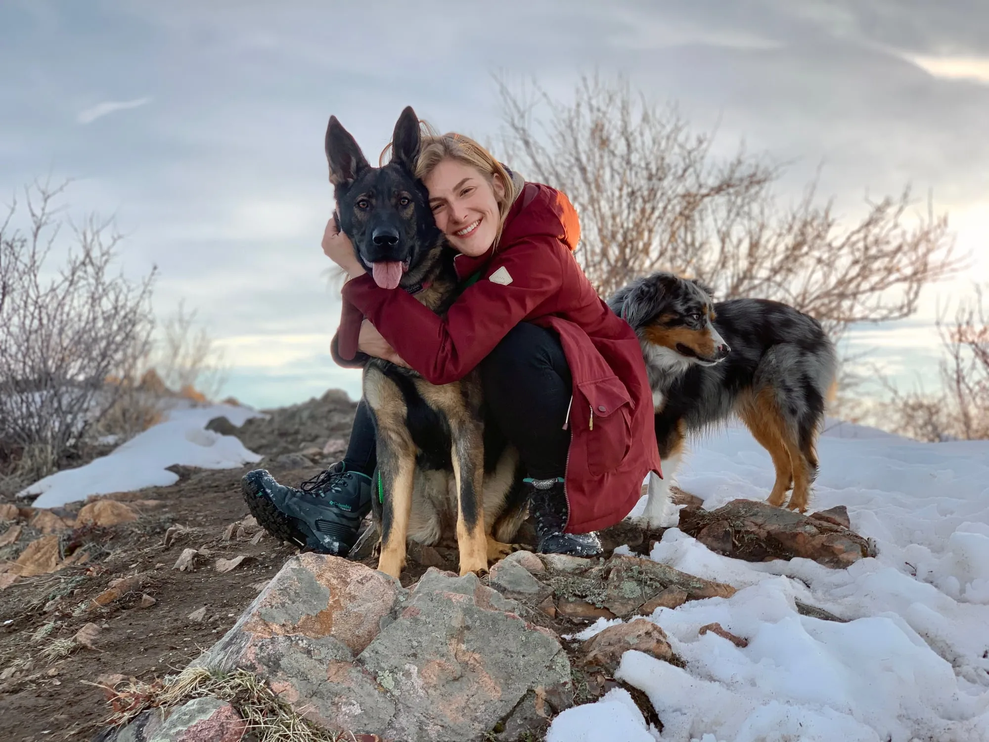 Yvonne hugging a dog in the snow